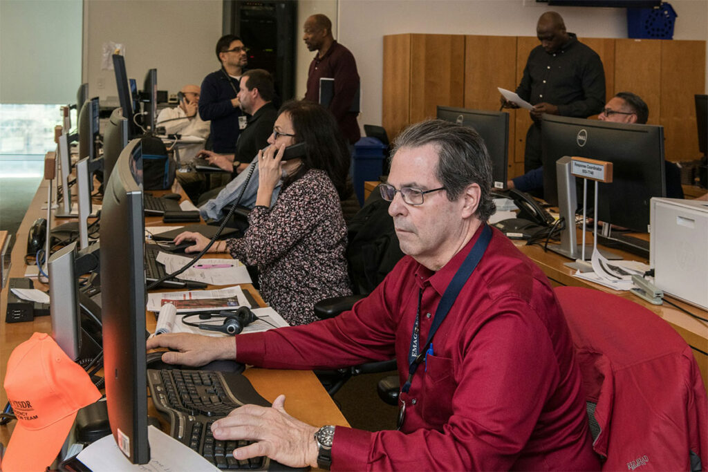 A group of healthcare professionals working at separate workstations