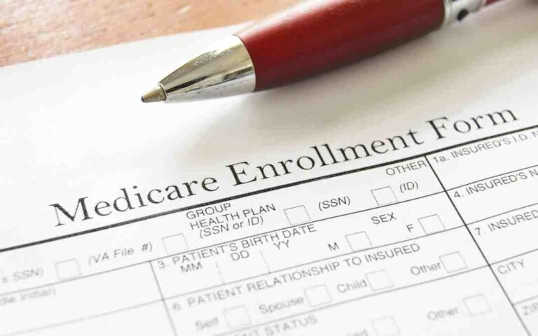 A close-up image of a Medicare enrollment form below a pen