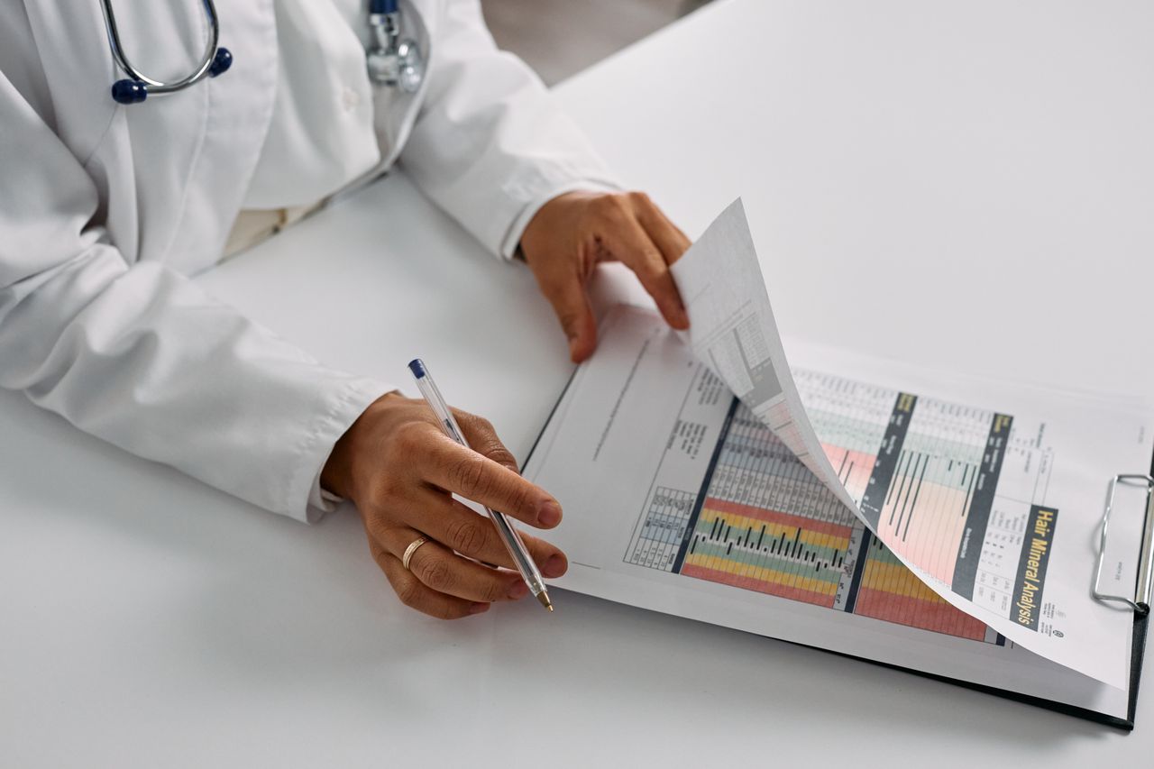 A doctor reviews medical billing reports