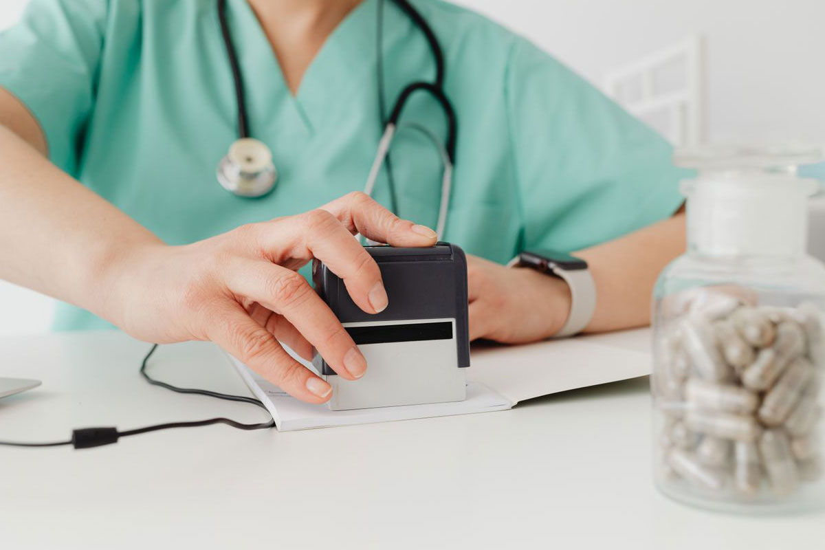 A woman stamping medical billing.